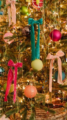 a christmas tree decorated with ornaments and ribbons