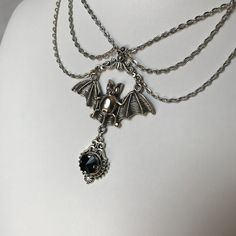 "This gothic vampire inspired necklace is made with an antiqued silver plated bat. filigrees and findings, accented with sparkling glass crystals in JET BLACK. Decorated portion is 6\" wide and centerpiece is 2 7/8\" tall in the center. Necklace is adjustable 15-18\" with a lobster clasp and chain extender in the back. If you would like a different length or stone color, please send us a message." Witchy Metal Jewelry For Halloween, Gothic Costume Choker Necklace, Gothic Pendant Necklace For Halloween, Gothic Sterling Silver Choker Jewelry, Gothic Sterling Silver Choker Necklace, Gothic Sterling Silver Choker, Gothic Costume Jewelry Choker, Elegant Metal Necklaces For Halloween, Halloween Gothic Pendant Jewelry