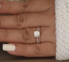 a woman's hand with a ring on it and a diamond in the middle