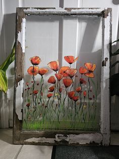 an old window with flowers painted on it