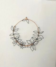 a wire wreath is hanging on the wall