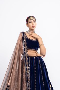 Navy blue without sleeve blouse paired with double tier lehnga and tissue dupatta.From Vvani Vats Mahnoor collection.DELIVERY TIMEPlease allow 8-12 weeks for your outfit to arrive.FABRIC DETAILSVelvet, TissueProfessional cleaning only. Blue Pre-draped Saree With Dupatta For Reception, Elegant Blue Choli With Traditional Drape, Blue Choli With Dupatta For Party, Elegant Blue Sets With Unstitched Blouse, Festive Blue Pre-draped Saree For Wedding, Blue Cutdana Sharara For Party, Blue Cutdana Dress For Reception, Elegant Blue Lehenga With Dori Work, Blue Pre-draped Saree For Navratri Reception