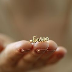 "14K Solid Gold Name Ring-Dainty Name Ring- Custom Stacking Name Ring - Birthday Gift- Bridesmaid-Gift For Mom-Gift For Her 14K Solid Gold Name ring will be handmade with your desired, Here is a dainty, delicate and simple, yet classy minimalist Name Ring . This is 14k Solid Yellow Gold. (this necklace is 100% real. It's not plated ) Perfect for everyday use. A beautiful customized gift for yourself or someone you care for. \"What's in a name?\" Spell out a name and let us create a beautiful gif Personalized Dainty Rings For Birthday, Dainty Personalized Ring For Birthday, Dainty Personalized Birthday Ring, Dainty Gold Ring With Custom Name, Gold Nameplate Ring For Gift, Adjustable Gold Rings For Birthday Gift, Gold Ring For Birthday Gift, Gold Ring Jewelry For Birthday Gift, Gold Rings For Mother's Day Birthday Gift