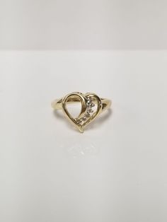 "Thanks for shopping our vintage estate store. We tend to sell well below wholesale and truly hope you enjoy all of our items. Many of the items are one of a kind, so please enjoy scrolling through the pictures and hopefully something will catch your eye. Brown spots are from camera. Estate 10k yellow gold .05ct diamond heart ring.  There are 6 small diamonds in the setting. Sweet ring. Ring size: 7 Setting: 1/2\" Band width: 2mm Weight: 2.55 grams Very sweet ring. Marked 10k." Sweet Ring, Diamond Heart Ring, Brown Spots, Filigree Ring, Ring Ring, Diamond Heart, Heart Ring, Jewelry Rings, Etsy Accessories