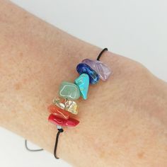 a woman's arm with four bracelets made out of glass beads on it