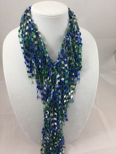 A beautiful and unique handmade accessory that shimmers and portrays a beaded look! Each Fringed Scarf Necklace is handmade and can be worn multiple ways. Item is lite weight and is available in many stunning great colors. Comes packaged in an organza bag. A great gift item. Fringed Scarf Necklace is approx. 66 inches in length and is made of 97% Nylon and 3% Lurex. Handwash in cold water and lay flat to dry. Each item is made by hand and slight variations may occur. Blue Bohemian Necklaces For Party, Bohemian Beaded Lariat Necklaces For Party, Bohemian Beaded Lariat Necklace For Parties, Bohemian Lariat Beaded Necklaces For Party, Blue Lariat Jewelry For Party, Unique Colorful Party Beads, Multi-strand Large Bead Party Jewelry, Multicolor Lariat Necklaces For Party, Multicolor Lariat Necklace For Party