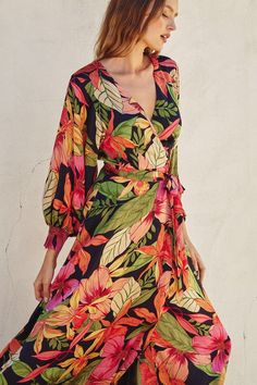 Our new Oceania Garden Midi Dress is the perfect addition to your summer wardrobe! This new arrival features a v-neckline, long bubble sleeves, a belted tie waistband, and a wrap design. Absolutely perfect for any formal occasion! polyester hand wash with cold water hang to dry V-neck Wrap Dress With Tie Waist For Garden Party, Chic Wrap Dress With Surplice Neckline For Garden Party, Chic Surplice Neckline Wrap Dress For Garden Party, Garden Party Dress With Tie Waist And Surplice Neckline, Belted Beach Dress With Surplice Neckline, Vacation Surplice Neckline Belted Dress, Belted Surplice Neckline Beach Dress, Vacation Dress With Belted Surplice Neckline, V-neck Belted Midi Dress For Vacation