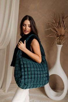 The Olivia Quilted Tote is both functional and stylish, available in forest green, sand grey, black, or tan. Measuring 20" x 7" x 15", this spacious tote features a secure zipper closure and a 27" long strap for comfortable carrying. The water-resistant inner lining helps protect your belongings, while two interior pockets keep your essentials organized. Additionally, two exterior side pockets offer convenient access to frequently used items. Perfect for daily use or weekend getaways, the Olivia Large Capacity Green Bag For Fall, Green Hobo Bag With Zipper Closure For On-the-go, Green Large Capacity Bags For Winter, Versatile Travel Bags For Winter, Versatile Winter Travel Bags, Green Shoulder Bag For Fall, Versatile Green Hobo Bag With Zipper Closure, Green Nylon Shoulder Bag With Top Carry Handle, Green Bag With Removable Pouch For Fall