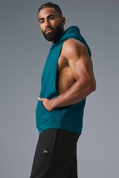 Stay cozy without sacrificing style in the Renown Sleeveless Hoodie. It has deep armholes, a kangaroo pocket, and a laid-back cut. And wait till you feel the Alo signature Renown fabric—it's smooth on the outside, a little fleecy on the side, and heavyweight for a just-right drape. Add shorts and you’re covered from the gym to the street. Athleisure Tops With Kangaroo Pocket For Streetwear, Sleeveless Cotton Hoodie For Loungewear, Athleisure Hoodie Top With Pockets, Alo Yoga Hooded Top With Drawstring Hood, Stretch Hoodie Top With Pockets, Athleisure Top With Kangaroo Pocket And Stretch, Athleisure Stretch Top With Kangaroo Pocket, Stretch Athleisure Top With Kangaroo Pocket, Sporty Sleeveless Alo Yoga Tank Top