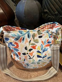 Gorgeous floral pattern bag.  Made with canvas exterior and fabric lining.  One of a kind.  Interior is orange checked canvas fabric.  Bag has two nice sized pockets on interior and one zippers pull pocket.  Four metal feet on bottom.  Magnetic snap closure on top.  Great quality, cork accents.  Can wear as a handbag or crossbody bag.  Will last for years to come.  Friends will go crazy over this handmade bag! Multicolor Canvas Shoulder Bag With Zipper Closure, Multicolor Fabric Bags With Zipper Closure, Daily Use Fabric Shoulder Bag With Zipper Pocket, Fabric Shoulder Bag With Zipper Pocket For Daily Use, Fabric Shoulder Bag With Zipper Pocket For Travel, Spring Canvas Bag With Zipper Pocket, Fabric Tote Shoulder Bag With Zipper Pocket, Orange Cotton Shoulder Bag For Travel, Orange Cotton Travel Shoulder Bag