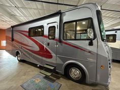 an rv parked in a garage next to other vehicles