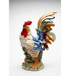 a colorful rooster figurine sitting on top of a table