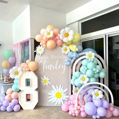 a birthday party with balloons and flowers in the shape of numbers, including an 8