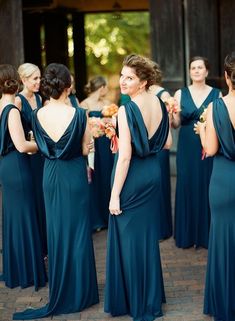 a group of women in long dresses standing next to each other on a brick floor