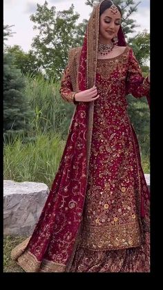 a woman in a red and gold wedding dress