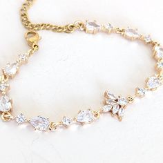 A single strand of diamonds will beautifully complement any wedding dress. Diamonds go with everything, just as lab diamonds go with every color.The CZ marquise will make a perfect finishing touch to your elegant look.DETAILS● Designed and handcrafted by ©JazzyAndGlitzy● This delicate drop and leaf-designed bridal bracelet feature AAA+A grade cubic zirconium.And the finish is with rhodium-plated silver or rose gold.● The bracelet measures 6 inches long + 2 inches extender chain.● Lead, nickel, a Wedding Dress Diamonds, Cubic Zirconia Bracelet, Bridal Bracelet, Tennis Bracelet, Lab Diamonds, Leaf Design, Silver Bracelets, Rhodium Plated, Or Rose