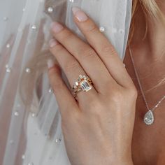 a woman wearing a wedding ring and veil