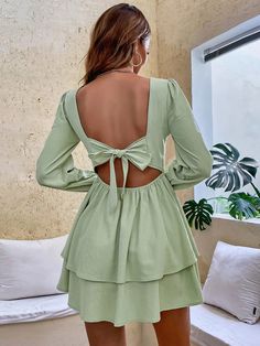 The ncocon green ruffles dress stole our hearts at first glance! Crafted from sheer woven fabric, this chic dress boasts a darted bodice and a square framed by long puff sleeves with elasticized, ruffled cuffs. Spin around to reveal an alluring back cutout (with double top button closure) that sits atop a fitted waist and an A-line mini skirt finished with a flirty ruffled hem. A hidden back zipper/clasp ensures a comfortable and secure fit. This dress is the perfect choice for an elegant and so Green Tiered Mini Dress For Party, Green Mini Dress With Ruffle Hem, Green Ruffled Mini Dress, Light Green Fitted Dress For Brunch, Chic Green Mini Dress With Ruffles, Chic Green Tiered Mini Dress, Green Long Sleeve Dress With Ruffle Hem, Green Fitted Tiered Mini Dress, Fitted Green Tiered Mini Dress