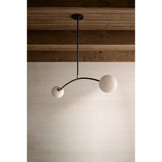 three light fixtures hanging from the ceiling in a room with wood paneling and white walls