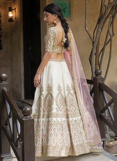 Featured here is an Ivory Raw Silk lehenga set embellished with traditional zardozi, resham work cutdana, sequins and dabka. Teamed with a fully embroidered blouse and an ivory dupatta. An additional embroidered blush dupatta completes the bridal look. Composition: Lehenga and Blouse - Raw Silk, Dupatta- Net Care: Dry Clean Only and Vacuum Storage This product can be customised for colour, sleeves, length of blouse and neck design Delivery : 8-10 weeks as the product is hand crafted. For more information and sizes please contact fabiliciousfashion@gmail.com or visit our Copenhagen studio.About the Designer : Angad Singh's journey in the world of fashion started with at an early age as he grew up in a family business that was immersed in couture. Seeking to expand his knowledge, Angad made Off White Embroidered Choli For Designer Wear, Designer Embroidered Off White Choli, Designer Embroidered Off-white Choli, White Art Silk Lehenga With Intricate Embroidery, White Raw Silk Lehenga With Intricate Embroidery, White Lehenga With Intricate Embroidery In Raw Silk, Bollywood Style Cream Choli With Pallu, Festive Embroidered Off White Lehenga, Festive Embroidered Off-white Lehenga