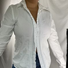 Love this 90s era vintage crisp cotton button down collared blouse. Features pleating and lace detail for an effortless parisian chic look when paired with denim, or a true cottagecore vibe with a white skirt. LABEL: Rafaella MATERIAL: 100% Cotton Size: (label size 10)  Modern Size - recommended for a medium, refer to measurements for fit details. Model is a medium. Excellent Vintage Condition MEASUREMENTS IN INCHES (laid flat + unstretched double where needed) : PIT TO PIT: 19.5 WAIST: 18 LENGTH: 24.5 Each vintage piece has been preloved. Minor fading + wear is expected & often adds to the character. All items are cleaned & from a smoke & pet free building. We hope you appreciate this find as much as we do. Casual Slim Fit Button-up Blouse, Classic Fitted Everyday Shirt, Classic Slim Fit Daywear Blouse, Classic Slim Fit Blouse For Daywear, Elegant Everyday Cotton Shirt, Feminine Button-up Tops For Everyday, Classic Fitted Blouse For Everyday, Fitted Long Sleeve Shirt For Everyday, Classic Slim Fit Tops For Daywear