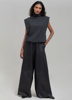 Color: Black Midweight smooth leather Relaxed fit Wide leg Elasticated waistband Side seam hip pockets Slip-on style Unlined 100% Lamb Skin Dry Clean By The Frankie Shop. Made in India Modern Leather Pants With Pockets For Work, High-waisted Leather Pants For Business Casual, Sleek Black Wide-leg Leather Pants, Elegant Black Wide-leg Leather Pants, Modern Leather Trousers For Work, Modern Leather Bottoms For Business Casual, Black Leather Wide-leg Pants, Classic High-waisted Leather Pants For Work, High Waist Leather Pants For Work