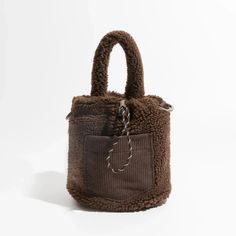 Embrace casual, comfy, and cozy style with the Teddy Pocket Bucket Bag. Crafted with soft-touch material, this bag features an extra detachable and adjustable strap, a corduroy pocket at the front, and adjustable drawstring closures. Perfect for a laid-back yet stylish look. Soft touch material Extra detachable & adjutable strap Corduroy pocket at front Adjustable drawstring closures Size: length 18cm (7.1inc) width 16cm (6.3inc) height 20cm (7.8inc) Strap size: height 12cm (4.7inc) Brown Contact Lenses, Green Contacts Lenses, Purple Contacts, Y2k Necklace, Streetwear Grunge, Baby Tees Y2k, Y2k Baby Tee, Cozy Style, Corsets And Bustiers