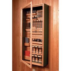 a wooden cabinet filled with lots of different types of items in it's compartments