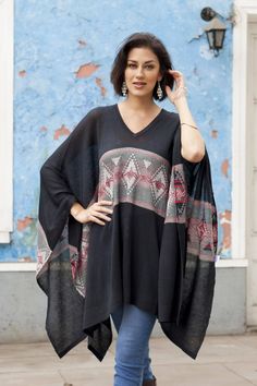 Woven from a lovely cotton blend in a solid black hue this poncho is designed by Peru's Alfredo Falcon. He decorates the center of this mysterious poncho with a stripe that displays subtle geometric patterns in hues of pearl grey and ruby. Black Shawl Poncho One Size, Black Bohemian Poncho With Batwing Sleeves, Black Oversized Bohemian Sweater, Bohemian Oversized Black Sweater, Oversized Black Bohemian Sweater, Black Poncho With Batwing Sleeve, Black Poncho With Batwing Sleeve One Size, Black Bohemian Poncho One Size, Bohemian Black Poncho For Fall