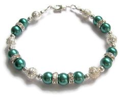 "This lovely bridesmaid bracelet has Teal pearls, sparkling rhinestones, 8 mm filigreed and 4 mm silver balls. They are all strung together on 49 strand beading wire for extra durability. I have used wire guards to prevent the wire from wearing through as an added precaution. There are silver plated beads that have been used as spacers. It can be made for any member of your bridal party from flower girl to Mother of the Bride. You can order a heart charm to be put on your bracelet. Please see li Silver Beaded Pearl Bracelet For Anniversary, Elegant Pearl Bracelet With Silver Beads For Wedding, Silver Pearl Bracelets For Mother Of The Bride, Elegant Silver Beaded Bracelets For Wedding, Elegant Silver Beaded Wedding Bracelets, Adjustable Silver Beads Bracelet For Wedding, Adjustable Silver Bead Bracelets For Wedding, Adjustable Silver Beaded Bracelets For Wedding, Silver Beaded Bracelets For Bridesmaids