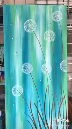 an acrylic painting of dandelions on a blue background