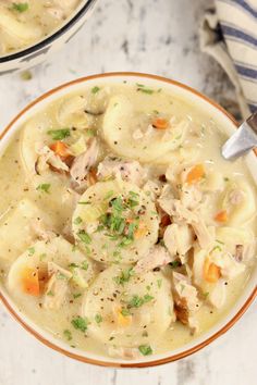 two bowls filled with chicken and dumplings soup