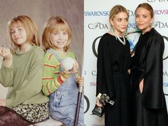 two women standing next to each other in front of a wall with pictures on it