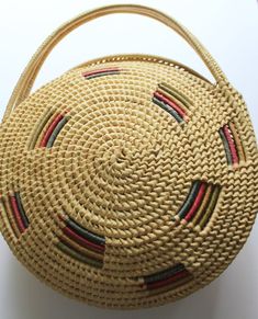 Here we have a cute Vintage Large Round Straw Raffia Tote Handbag from the 1970s.  It has two straw handles and it is made of woven raffia.  It has green, red and yellow raffia accents.  The bag measures 14 inches in diameter, 17 inches tall including the handle and 2 1/2 inches thick around the edges.  It is in fantastic shape minus some wear on the bottom.  This awesome purse would make a great addition to any outfit! Handmade Vintage Straw Bag, Vintage Brown Woven Straw Bag, Handmade Vintage Straw Basket Bag, Vintage Natural Straw Bag, Vintage Handwoven Beige Straw Bag, Retro Natural Straw Bag For Everyday Use, Retro Natural Straw Bag For Everyday, Retro Natural Bags For Vacation, Retro Natural Color Bags For Vacation