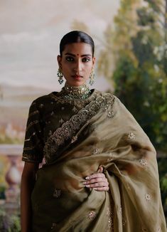 Editor's Note Introducing a mesmerizing ensemble - an olive green organza saree accompanied by a chanderi silk blouse adorned with antique gold dori, aari embroidery, and intricate hand embelli... Olive Green Organza Saree, Nepali Wedding Guest Outfit, Embroidered Pista Green Pre-draped Saree For Reception, Green Embroidered Pre-draped Saree For Reception, Green Art Silk Fabric With Intricate Embroidery, Intricate Embroidery Green Art Silk Fabric, Pista Green Chanderi Choli With Intricate Embroidery, Intricate Embroidered Pista Green Chanderi Choli, Green Intricate Embroidered Fabric For Navratri