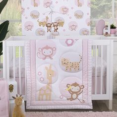 a baby crib bedding set with pink and brown animals