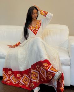 This Habesha Kemis, a traditional Ethiopian garment, radiates beauty and elegance, reflecting the rich cultural heritage and craftsmanship of Ethiopia. This exquisite dress showcases a perfect harmony of handwoven fabric, intricate embroidery, the use of Menen fabric, lightweight cotton, and quality thread, creating a stunning ensemble that captivates the eye and the heart. At the core of the Habesha Kemis lies the handwoven fabric, a testament to the skill and dedication of Ethiopian weavers. U Transitional Festive Dresses With Woven Motifs, Traditional Multicolor Long Sleeve Maxi Dress, Transitional Dresses With Woven Motifs For Traditional Ceremonies, White Bollywood Dresses With Traditional Patterns, Traditional Anarkali Dresses For Diwali, Traditional Long Dress With Traditional Patterns, Diwali Anarkali Dress With Traditional Patterns, Anarkali Dresses With Traditional Patterns For Diwali, Traditional Patterned Floor-length Maxi Dress For Eid