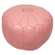 a pink leather poufce with an intricate design on the top and bottom, is shown