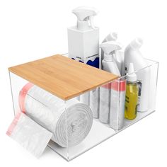 a wooden cutting board sitting on top of a counter next to bottles and other items