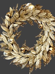 a gold wreath with ornaments on it