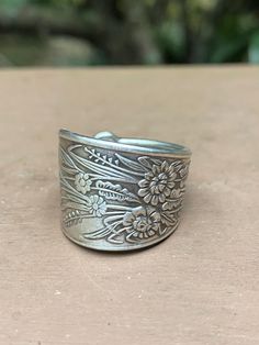 a silver ring sitting on top of a wooden table