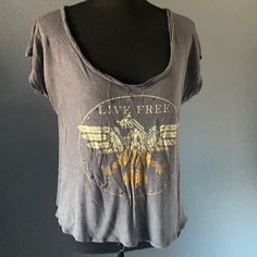 This Is A Cute Shirt Very Lightweight And Soft Distressed T-Shirt With Native American Design Of An Eagle And A Cute Little Brass Grommet Details On The Center. From A Smoke Free Home Size Extra Large But Run Small Grunge V-neck Tops For Summer, Grunge V-neck Summer Tops, Summer Grunge V-neck Tops, Casual Distressed V-neck Top, Distressed Short Sleeve Summer Tops, Casual Graphic Print Scoop Neck Top, Casual Distressed Short Sleeve Tops, Casual V-neck Top With Screen Print, Distressed T Shirt