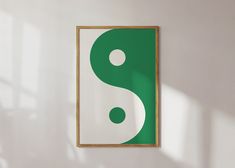 a green and white painting hanging on the wall