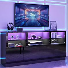 an entertainment center with a large television mounted on the wall and headphones in front of it