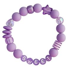 Add a sweet accent to your outfit with this adorably vibrant wrist candy. Stretchy letter bracelet with purple gumball beads & iridescent shapes