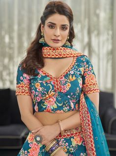 <ul>
<li style="text-align: justify;">Add a vibrant burst of color to your wardrobe with this elegant teal blue color lehenga formed with art silk material assembled with lovely floral print, stonework, sequins work, and dori work lace on the edge.</li>
<li style="text-align: justify;">This teal blue lehenga paired with a similar color art silk material choli originates with floral print, stonework, and embroidered lace border. It also reaches with a similar color soft ne Teal Blue Lehenga, Blue Color Lehenga, Print Motifs, Dori Work, Silk Lehenga Choli, Modest Evening Dress, Reception Lehenga, Party Wear Gown, Blue Lehenga