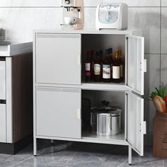 a kitchen cabinet with an open door and shelves on the side, next to a potted plant