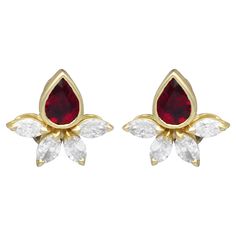 A stunning, fine and impressive pair of vintage Italian 1.90 carat ruby and 2.20 carat diamond, 18 karat yellow stud earrings; part of our diverse vintage ruby jewellery collections These fine and impressive vintage ruby earrings have been crafted in 18k yellow gold with 18k white gold fastenings. The organic shaped earrings are each ornamented with a feature pear faceted cut ruby, collet claw set to the upper portion. The rubies each surmount four individually claw set marquise cut diamonds, in a splayed formation. The earrings, for pierced ears, secure to the reverse with an 18k white gold post and hinged clip fastening. The interior of the hinged latch is hallmarked with the 18k gold fineness mark 750, the Italian town mark for Alessandria (star 2136, AL) and the French import gold mark Ruby Jewellery, Yellow Gold Earrings, Heart Brooch, Marquise Cut Diamond, Ruby Earrings, Ruby Jewelry, Yellow Gold Earring, Fine Earrings, Vintage Italian