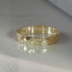 This minimalist band is made in SCS recycled yellow gold, and finished by hammering. Facets created by the hammer finish catch the light for an ever changing look that's great as a wedding ring and comfortable for every day wear. Design Specifications: - Type: Ring - Material: SCS recycled yellow gold - Width: 3.5mm - Thickness: 1.2mm - Finish: Hammered | Polished - Profile: Flat Classic Gold Rings, Hammered Gold Ring, Hammered Wedding Bands, Cute Engagement Rings, Hammered Rings, Everyday Rings, Rose Gold Band, Wedding Ring Designs, Gold Wedding Rings