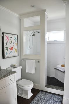 a bathroom with a toilet, sink and shower